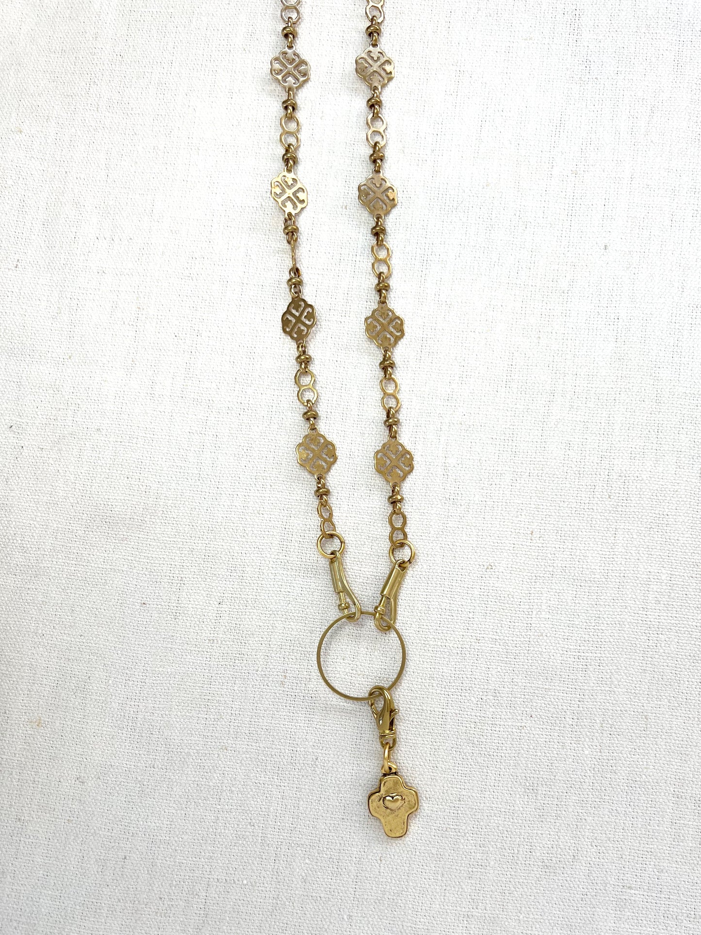 Gold necklace with a pendant on a white background
