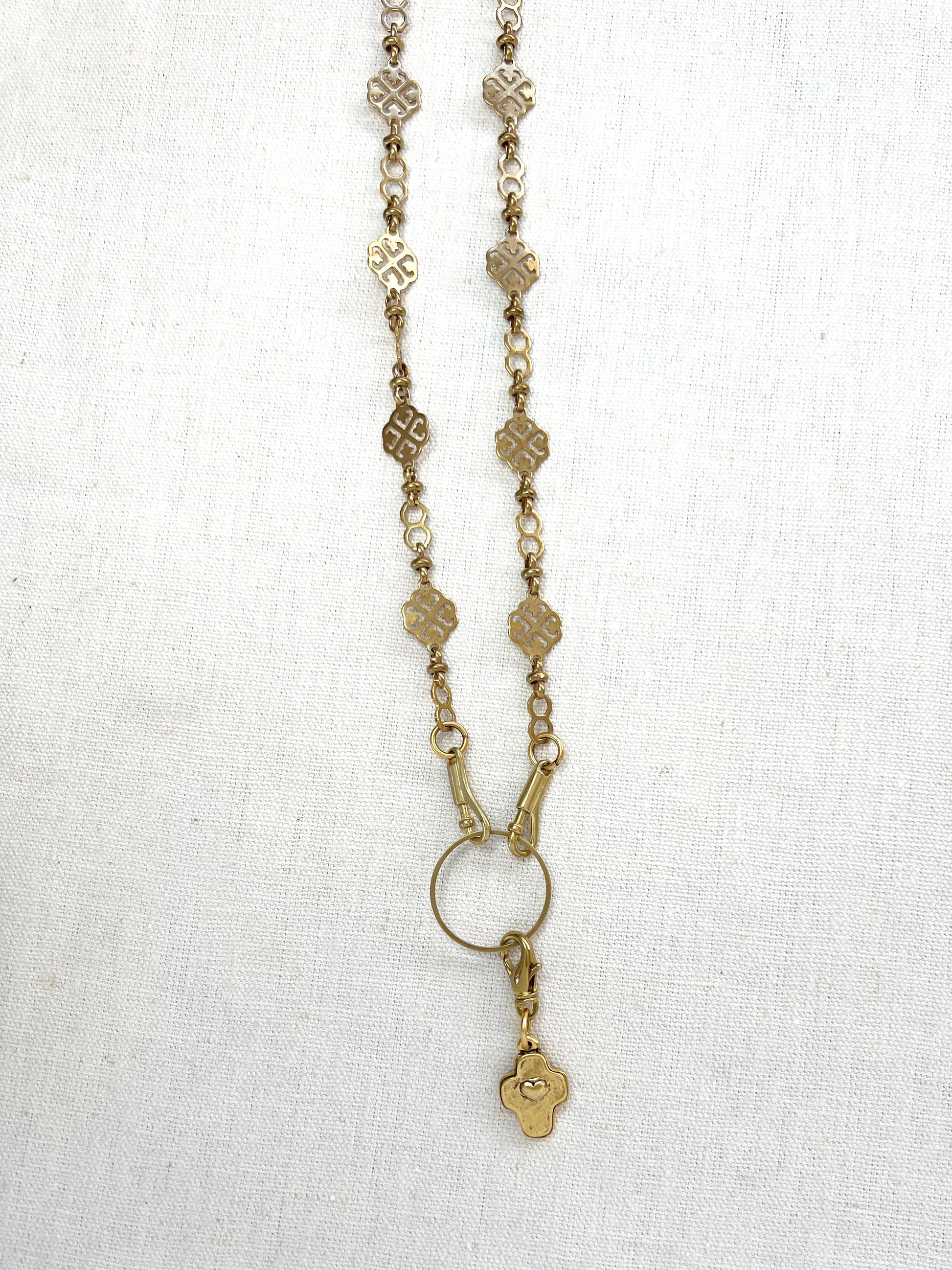 Gold necklace with a pendant on a white background