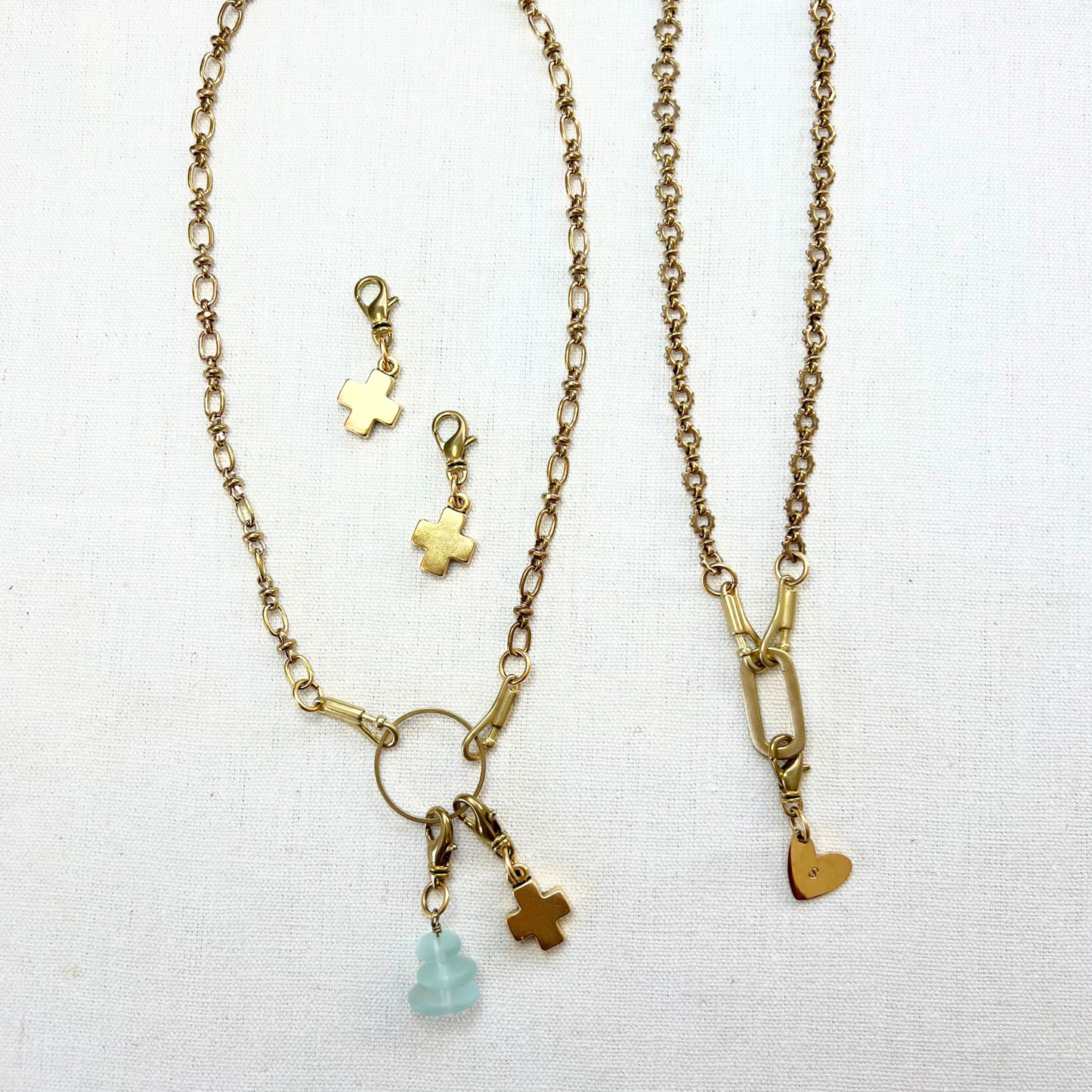 two charm holder necklaces with heart, sea glass and cross charms