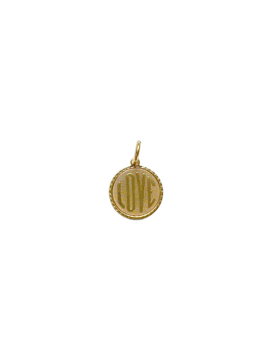 vintage brass charm with the word love on a white background