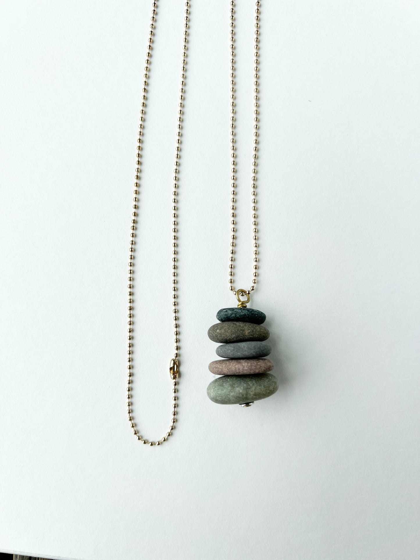 Necklace with a stack of stones pendant on a white background