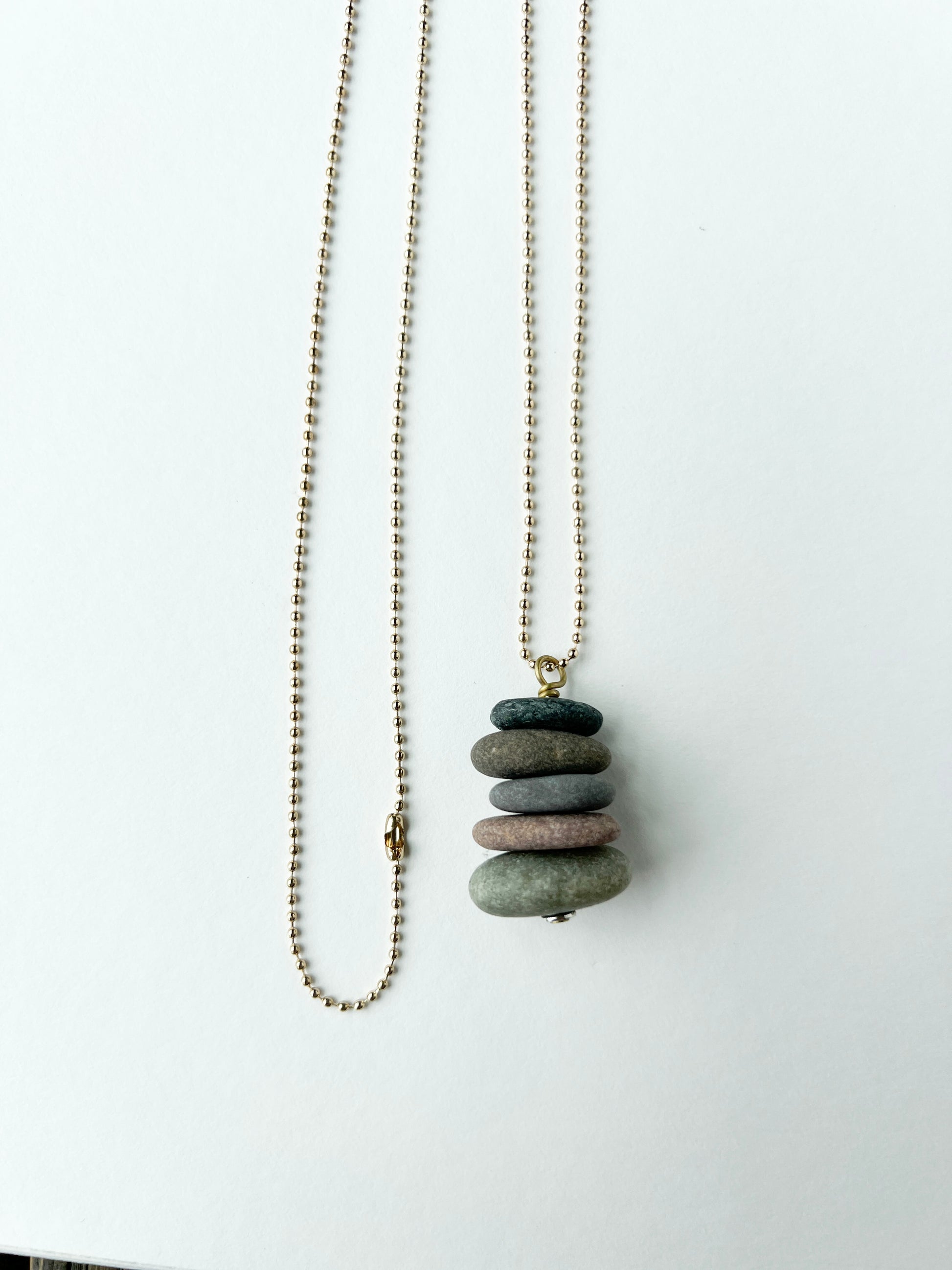 Necklace with a stack of stones pendant on a white background