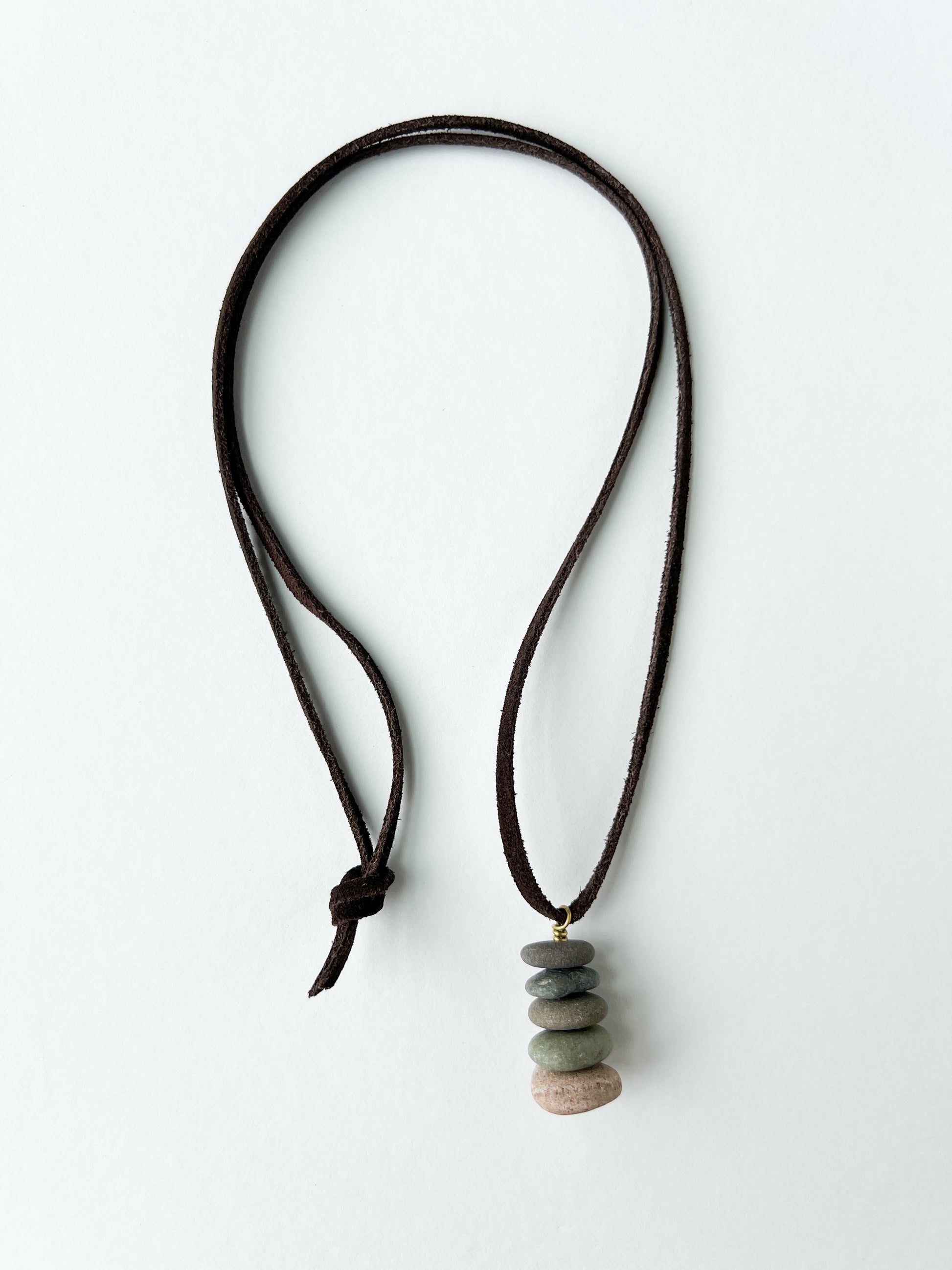 Necklace with stacked stone pendants on a white background