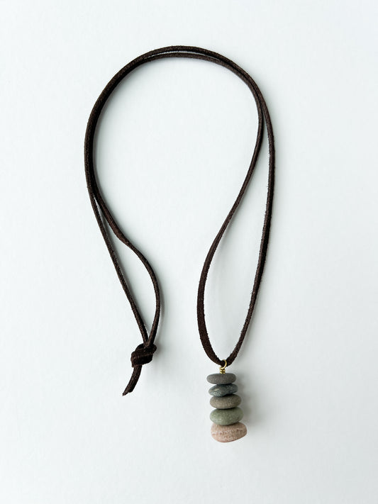 Necklace with stacked stone pendants on a white background