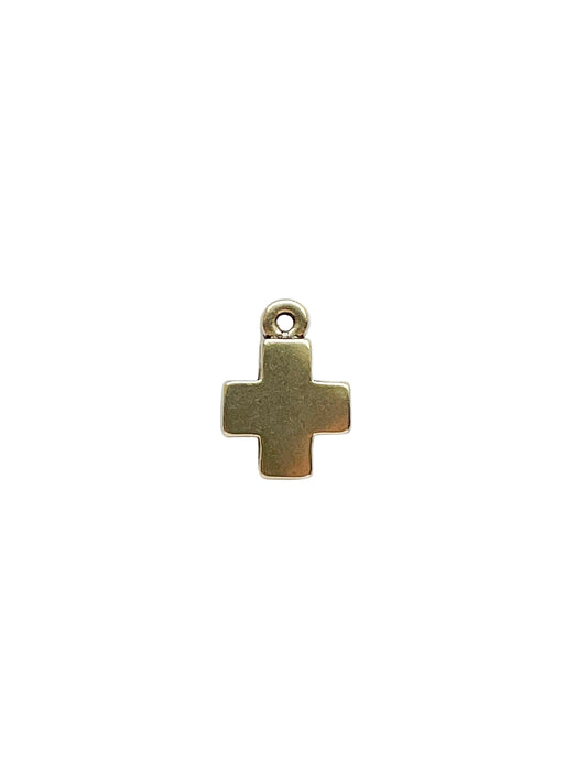 Gold cross pendant on a white background