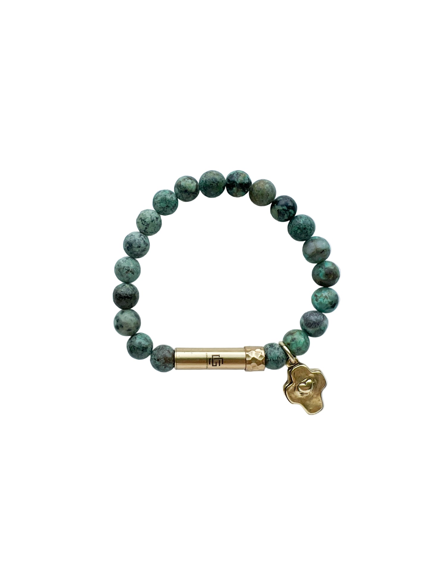 Green beaded bracelet with gold cross charm and brass tube clasp on a white background