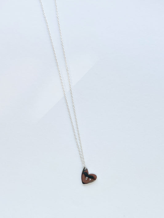 Heart-shaped pendant necklace on a light gray background