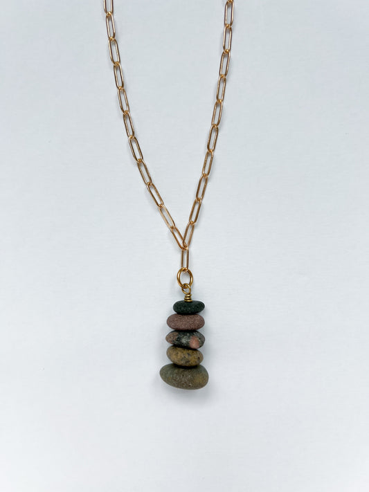 Brushed gold paperclip chain necklace with a 5 lake stones stacked in charm on a white background.