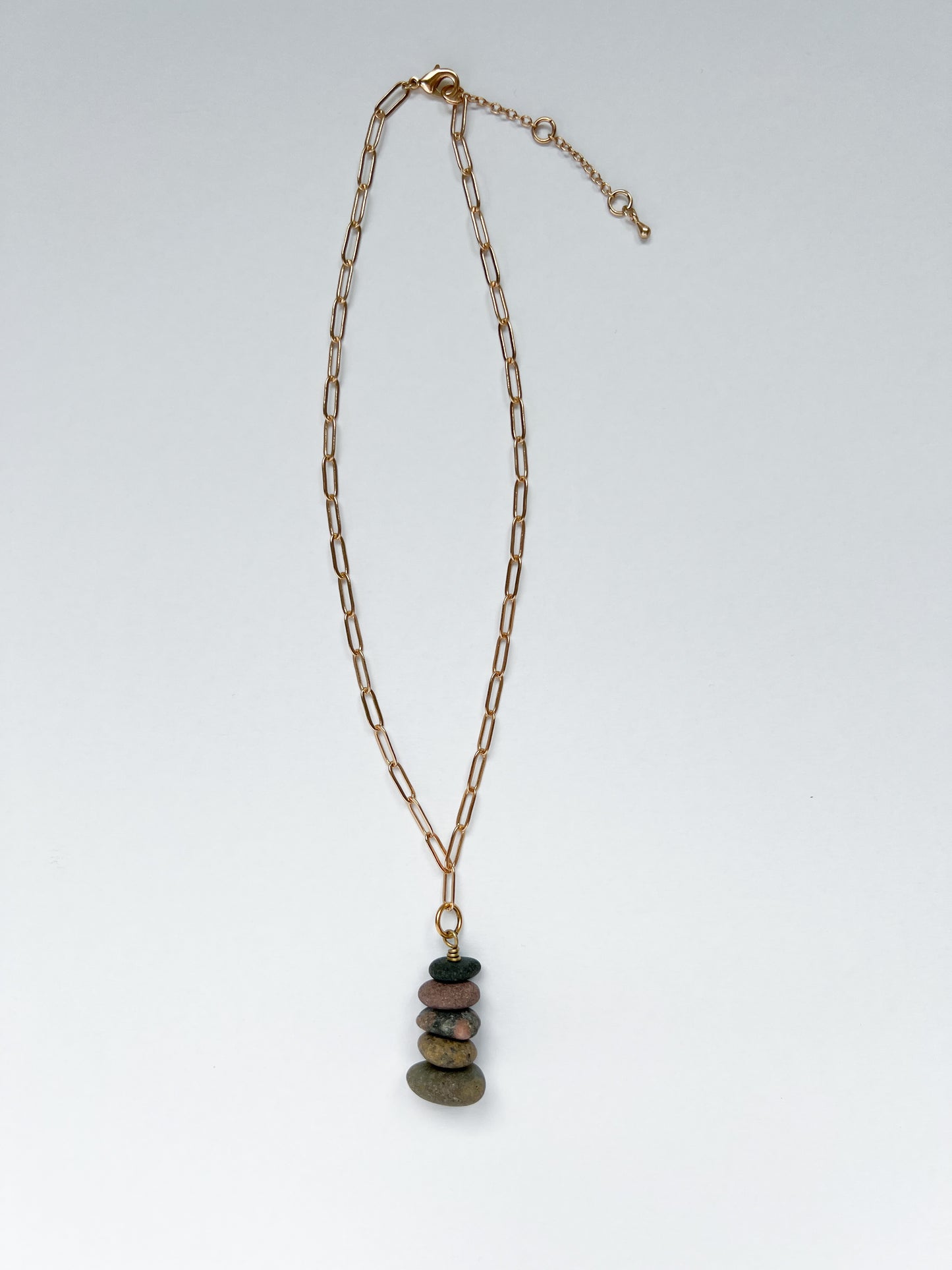 Brushed gold paperclip chain necklace with a 5 lake stones stacked in charm on a white background.