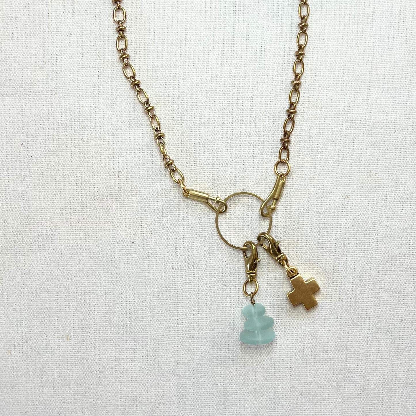 Necklace with charms on a light fabric background