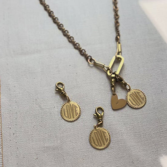 Video of a charm necklace with love token charms
